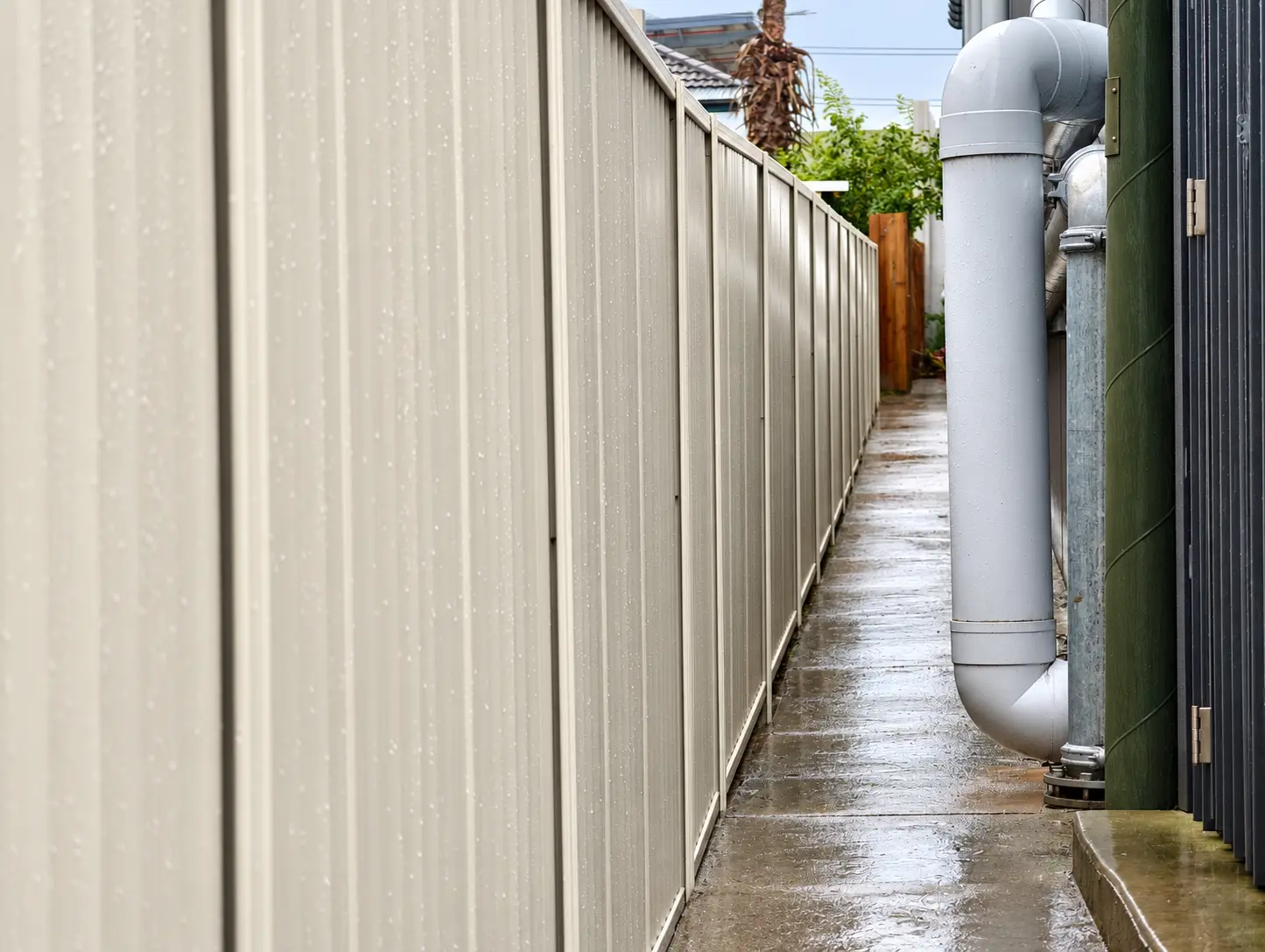 Close perspective showing the details of a cream Colorbond fence installation